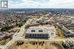 Hamilton condo for rent - A realtor logo is in the corner of an aerial view of a city.