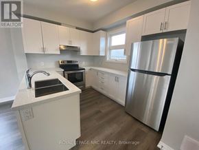 Niagara Falls (Morrison) townhouse for rent - A kitchen with white cabinets and a stainless steel refrigerator.