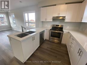 Niagara Falls (Morrison) townhouse for rent - A kitchen with white cabinets and a stainless steel oven.