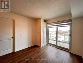 Pickering (Bay Ridges) condo for rent - A room with a sliding glass door leading to a construction site.