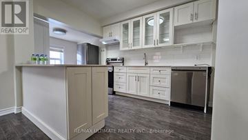 Toronto (Keelesdale-Eglinton West) apartment for rent - A kitchen with white cabinets and a grey countertop.