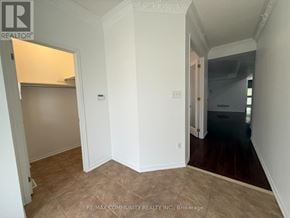 Oshawa (Taunton) apartment for rent - A room with white walls and a brown floor.