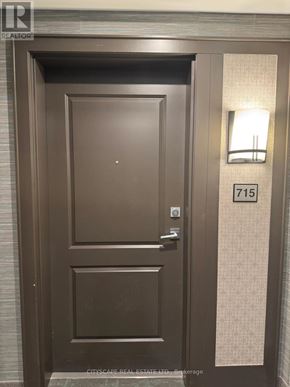Hamilton (Waterdown) condo for rent - A brown door with a glass window and a handle.