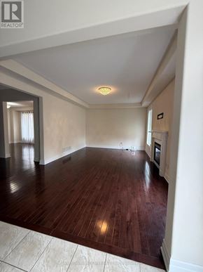 Oshawa (Samac) apartment for rent - A large empty room with wooden floors and a skylight.