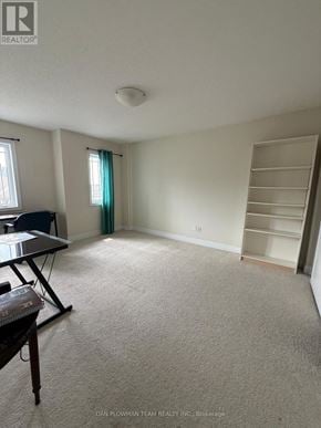 Oshawa (Samac) apartment for rent - A room with a desk and a chair in it.