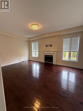Oshawa (Samac) apartment for rent - A room with a fireplace and wood flooring.