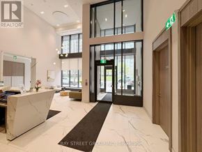 Toronto (Church-Yonge Corridor) condo for rent - A reception area with a marble counter and a green exit sign.