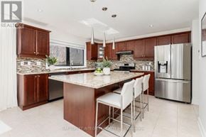 Oakville (Wm Westmount) apartment for rent - A modern kitchen with a center island and stainless steel appliances.