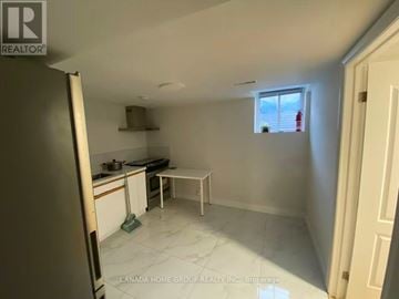 Toronto (Agincourt North) apartment for rent - A kitchen with white cabinets and a white fridge.