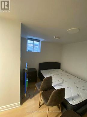 Toronto (Agincourt North) apartment for rent - A bedroom with a bed, chair, and window.