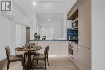 Toronto (Annex) condo for rent - A modern kitchen with a dining table set for two.