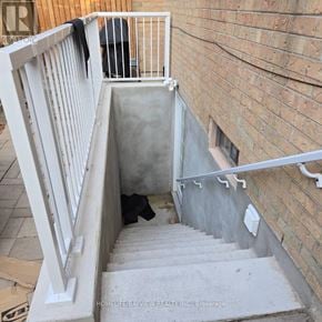 Markham (Thornlea) apartment for rent - A stairwell with a white railing and a brick wall.
