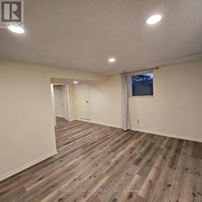 Markham (Thornlea) apartment for rent - A room with wooden flooring and a window with curtains.