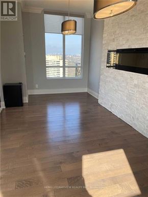 Toronto (Banbury-Don Mills) condo for rent - A living room with a fireplace and a view of the city.