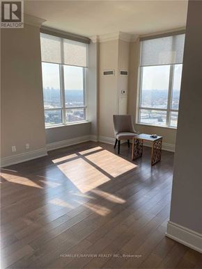 Toronto (Banbury-Don Mills) condo for rent - A room with a view of the city through large windows.