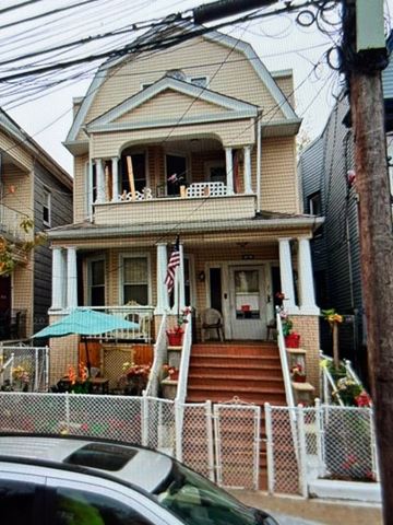 Jersey City apartment for rent - A house with a flag on the front porch.