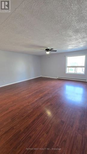 Innisfil multi-family for rent - A room with a wooden floor and a ceiling fan.