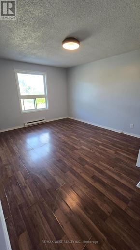Innisfil multi-family for rent - A room with wooden flooring and a window.