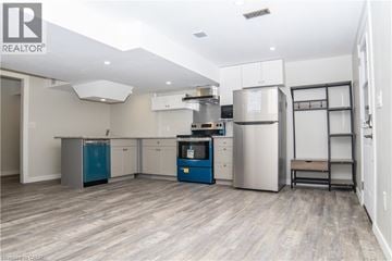 Caledonia apartment for rent - A modern kitchen with stainless steel appliances and a blue cabinet.