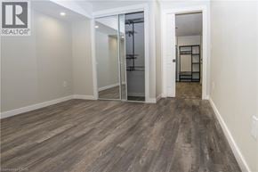 Caledonia apartment for rent - A room with a wooden floor and a glass door leading to another room.