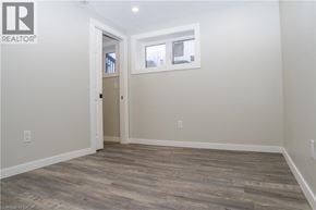 Caledonia apartment for rent - A room with a wooden floor and a door leading to another room.