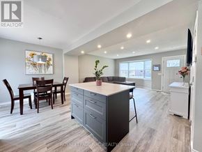 St. Catharines (Lakeport) apartment for rent - A well-lit kitchen with a dining table and chairs.