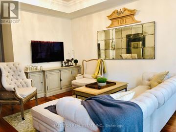 Toronto (Annex) condo for rent - A living room with a white couch and a wooden coffee table.