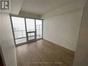 Toronto (Bayview Village) condo for rent - A room with a large window and wooden flooring.