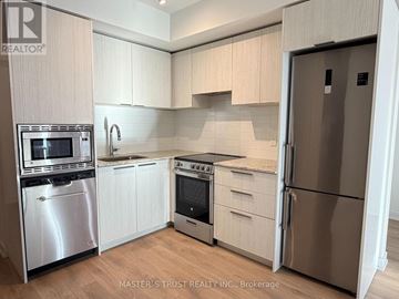 Toronto (Church-Yonge Corridor) condo for rent - A kitchen with white cabinets and stainless steel appliances.
