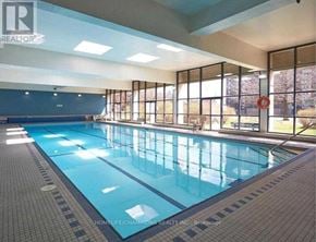 Toronto (Pleasant View) condo for rent - A large indoor swimming pool with tiled floors and walls.
