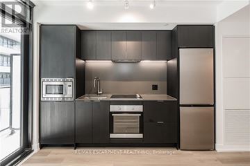 Hamilton (Beasley) condo for rent - A modern kitchen with black cabinets and stainless steel appliances.