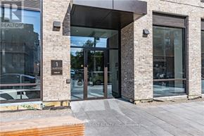 Hamilton (Beasley) condo for rent - The entrance to a building with a glass door and a brick wall.