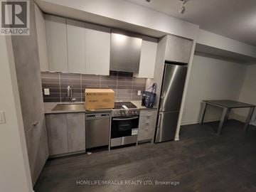 Toronto (Islington-City Centre West) condo for rent - A kitchen with stainless steel appliances and white cabinets.