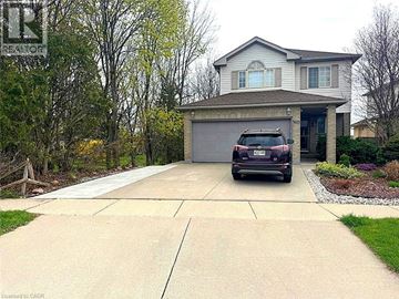 Waterloo apartment for rent - A house with a garage and a car parked in front.