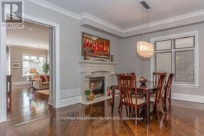 Toronto (Bedford Park-Nortown) apartment for rent - A dining room with a fireplace and a painting above it.