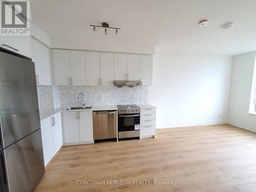 Markham (Unionville) condo for rent - A kitchen with white cabinets and a stainless steel refrigerator.