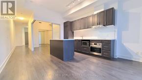 Markham (Unionville) condo for rent - A spacious kitchen with dark cabinets and stainless steel appliances.