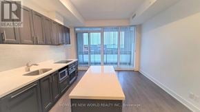Markham (Unionville) condo for rent - A kitchen with dark cabinets and a white countertop.