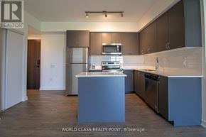 Barrie (Little Lake) condo for rent - A kitchen with a refrigerator, oven, and microwave.