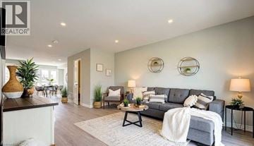 Kitchener condo for rent - A living room with a grey couch and a white blanket on it.