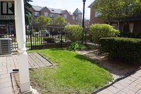 Markham (Unionville) townhouse for rent - A white pillar with the letters "R" and "REALTOR" on it is in the foreground of a residential area.