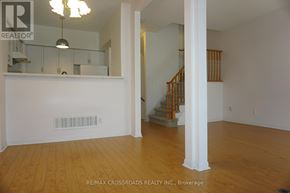 Markham (Unionville) townhouse for rent - A room with wooden floors and a staircase with wooden railings.