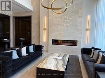 Richmond Hill (South Richvale) condo for rent - A modern living room with a black couch and a wooden coffee table.