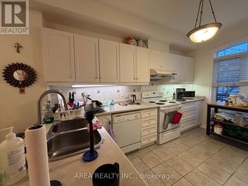 Toronto (Newtonbrook West) townhouse for rent - A kitchen with white cabinets and a sink.
