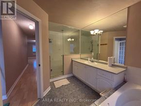 Toronto (Newtonbrook West) townhouse for rent - A bathroom with a sink, mirror, and shower.