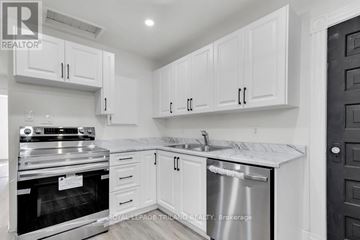 St. Thomas duplex for rent - A white kitchen with a stainless steel dishwasher and oven.