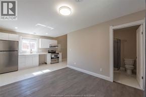 Windsor apartment for rent - A kitchen with a refrigerator, sink, and a window.