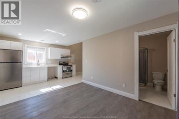 Windsor apartment for rent - A kitchen with a refrigerator, sink, and a window.