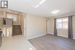 Windsor apartment for rent - A spacious living room with a staircase leading to the upper floor.