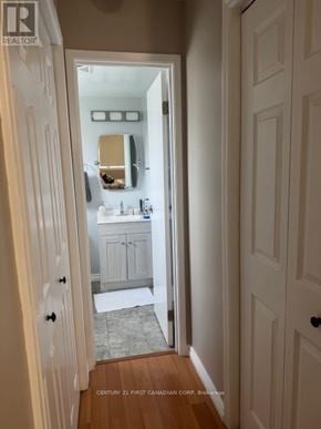 London North (North G) condo for rent - A bathroom with a sink and mirror is visible through an open door.